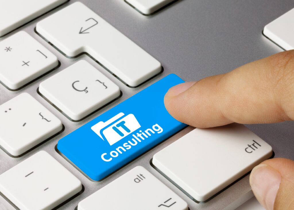 Close-up of a hand pressing a blue consulting key on a computer keyboard - representing expert IT support, and managed IT security solutions and services