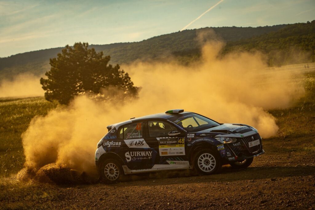 peugeot 208 rallying in Italy - image shows a dust cloud as car drifts